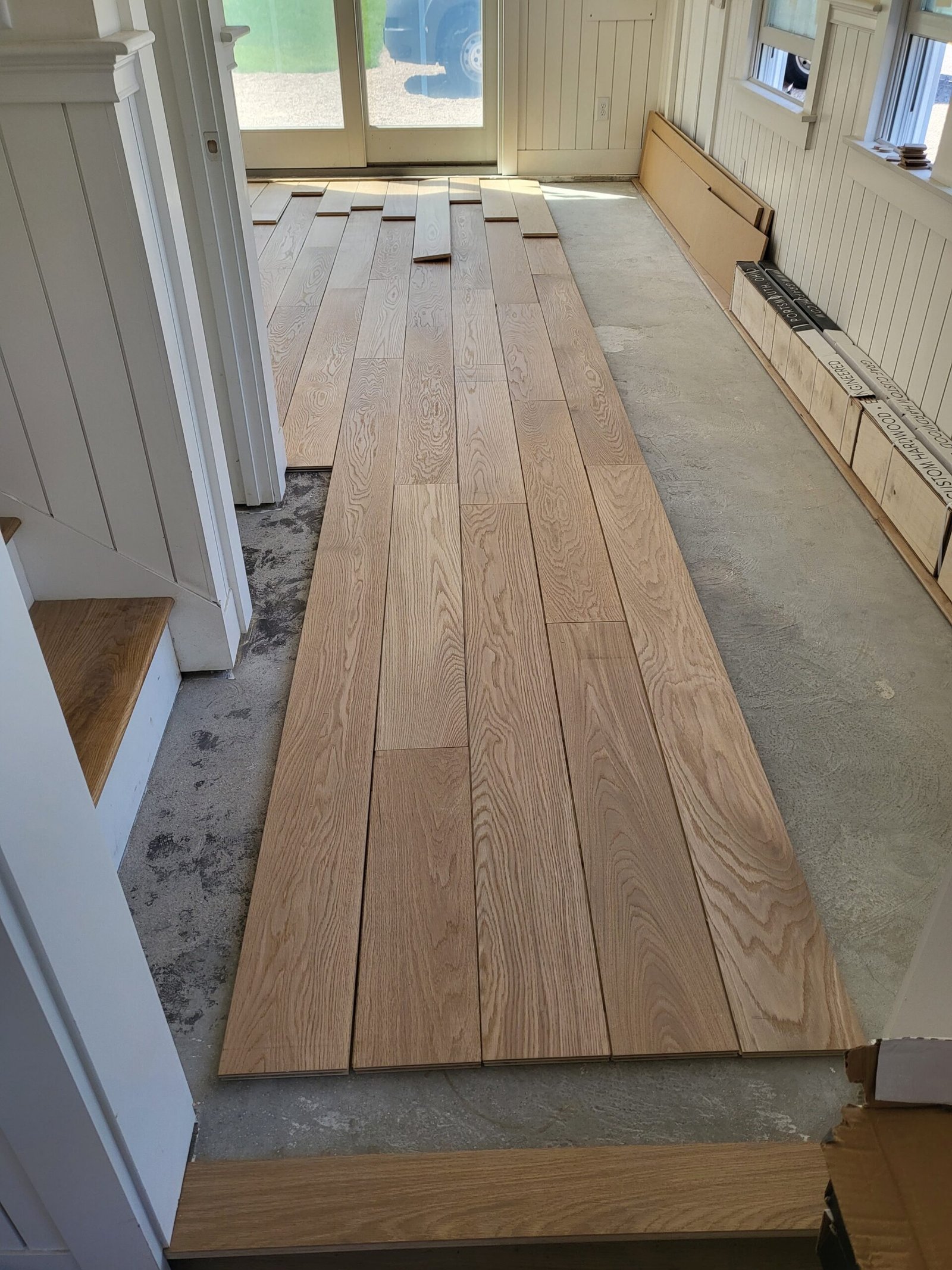 Hardwood floor installation in progress with wood planks laid out — I&P Flooring project